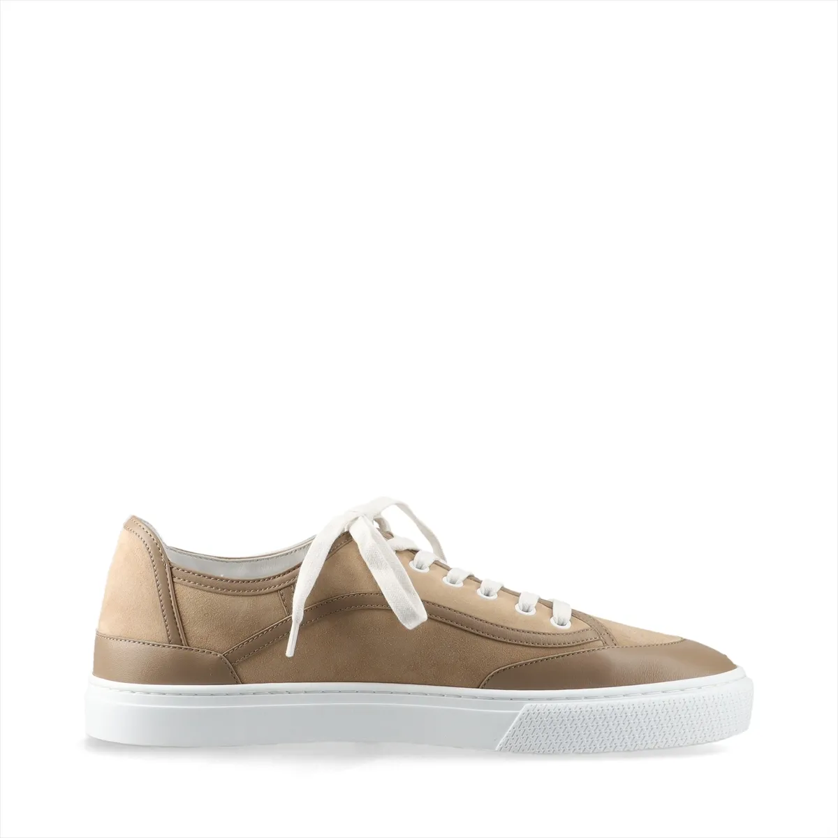 Brown suede low-top sneaker photographed in profile with a pale rubber sole.