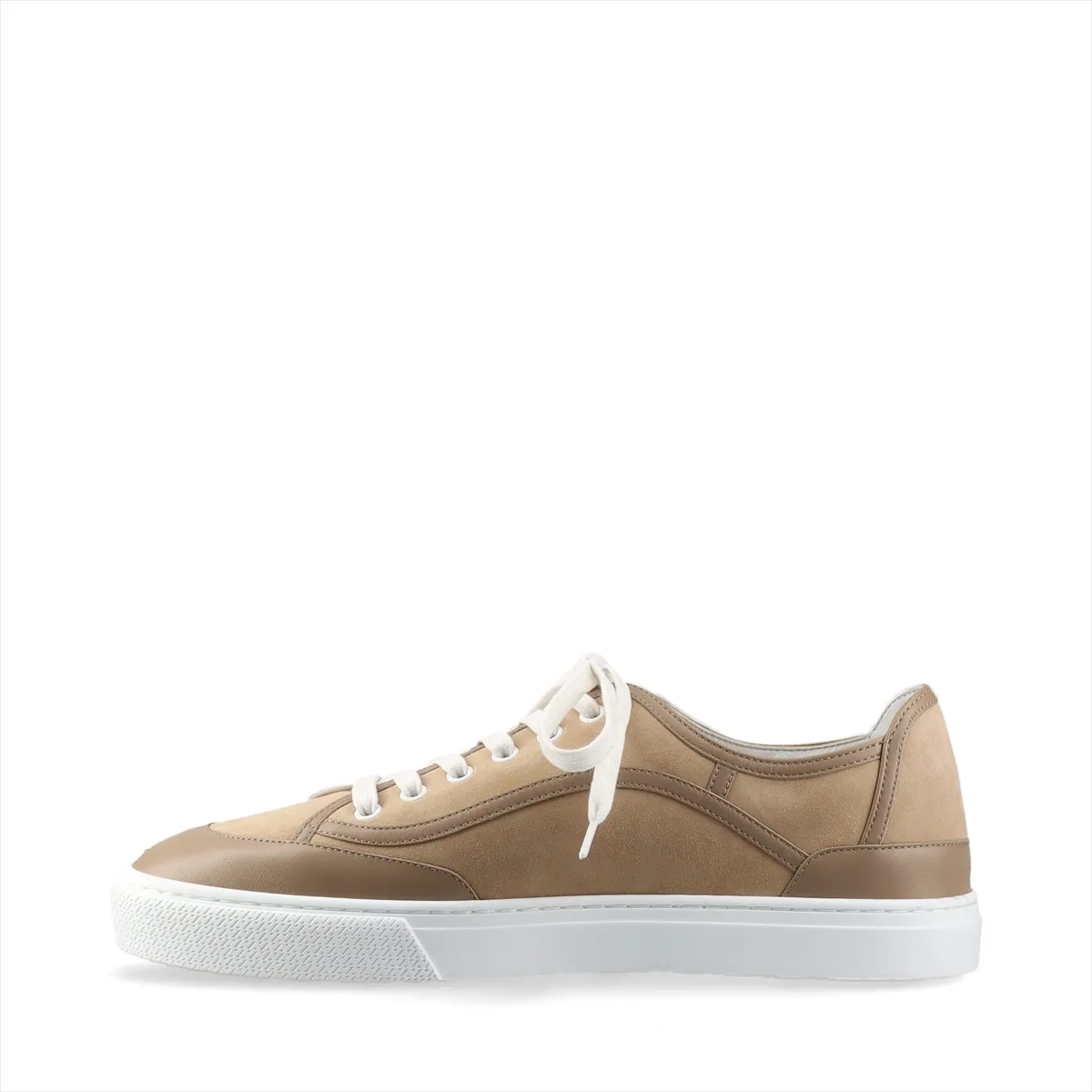 Brown suede low-top sneaker photographed in profile with a pale rubber sole.