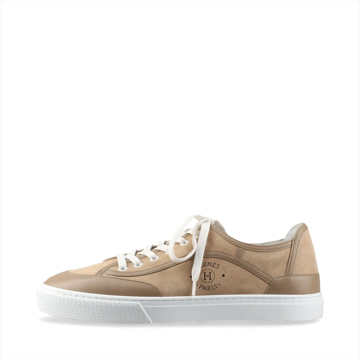 Brown suede low-top sneaker photographed in profile with a pale rubber sole.