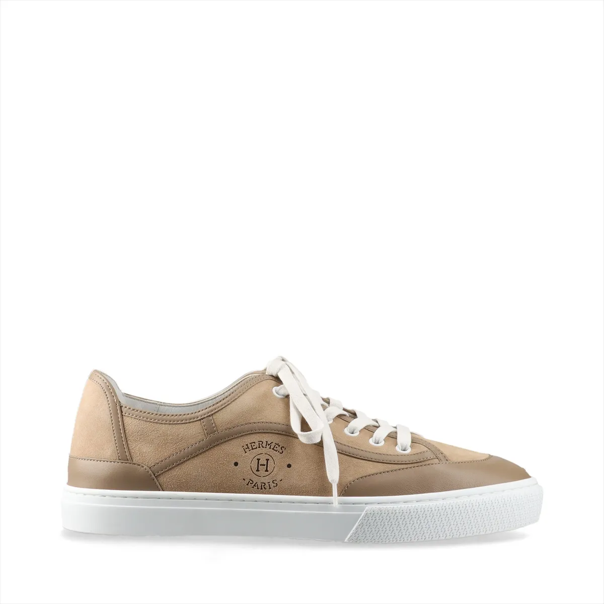Brown suede low-top sneaker photographed in profile with a pale rubber sole.