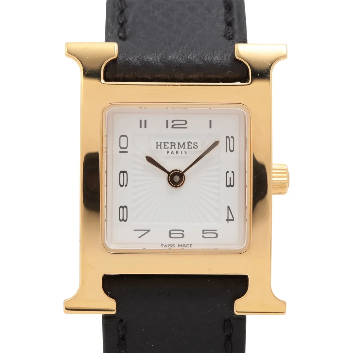 Square gold-tone watch case with white dial and slim leather strap.