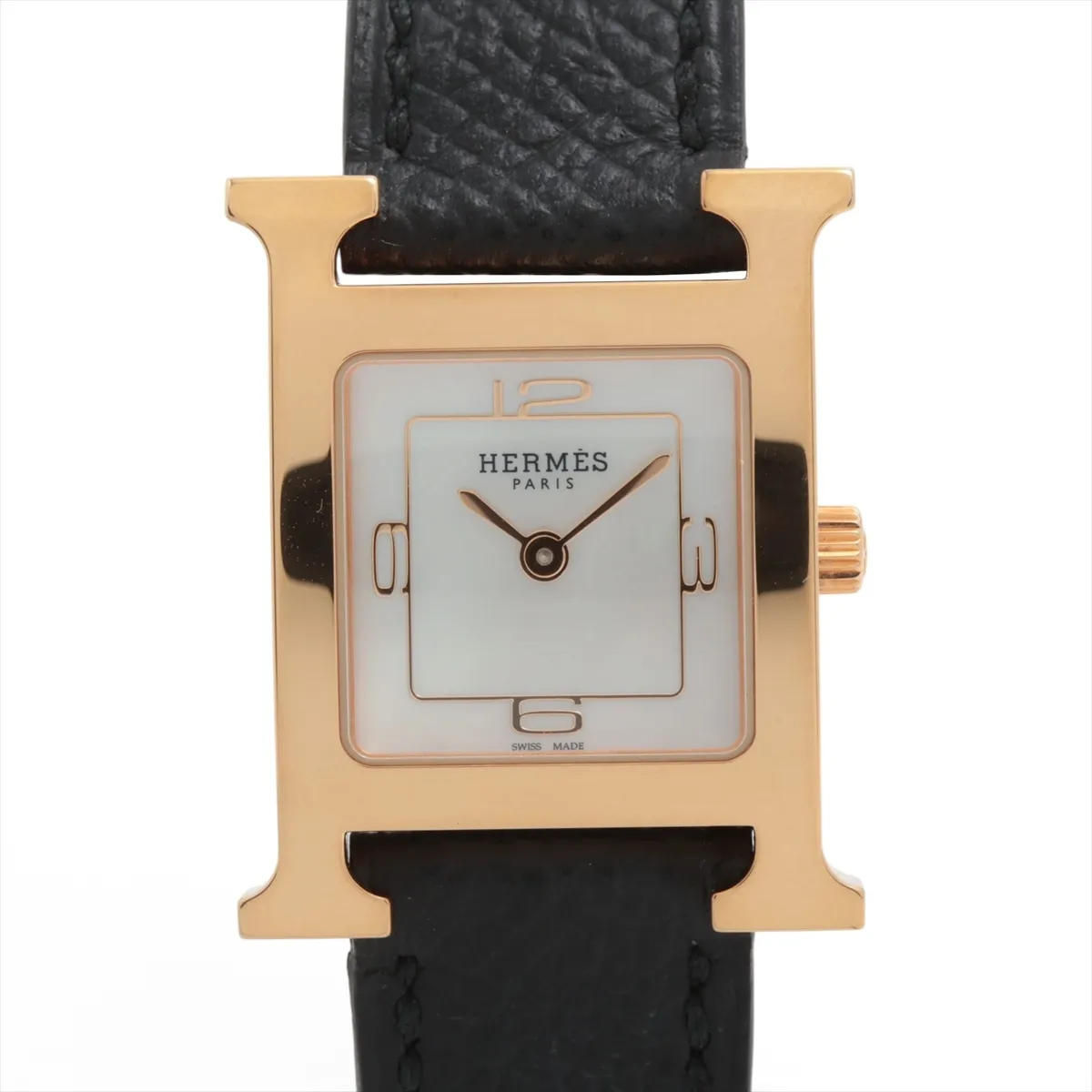 H-shaped gold-toned watch case with pale shell dial on a leather strap.