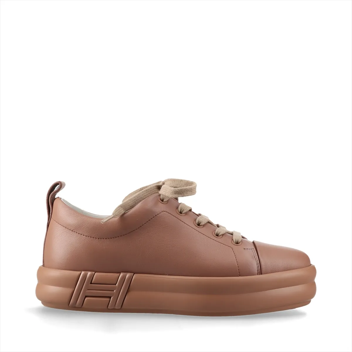 Low-top leather sneakers in a soft pink-brown tone with white soles.