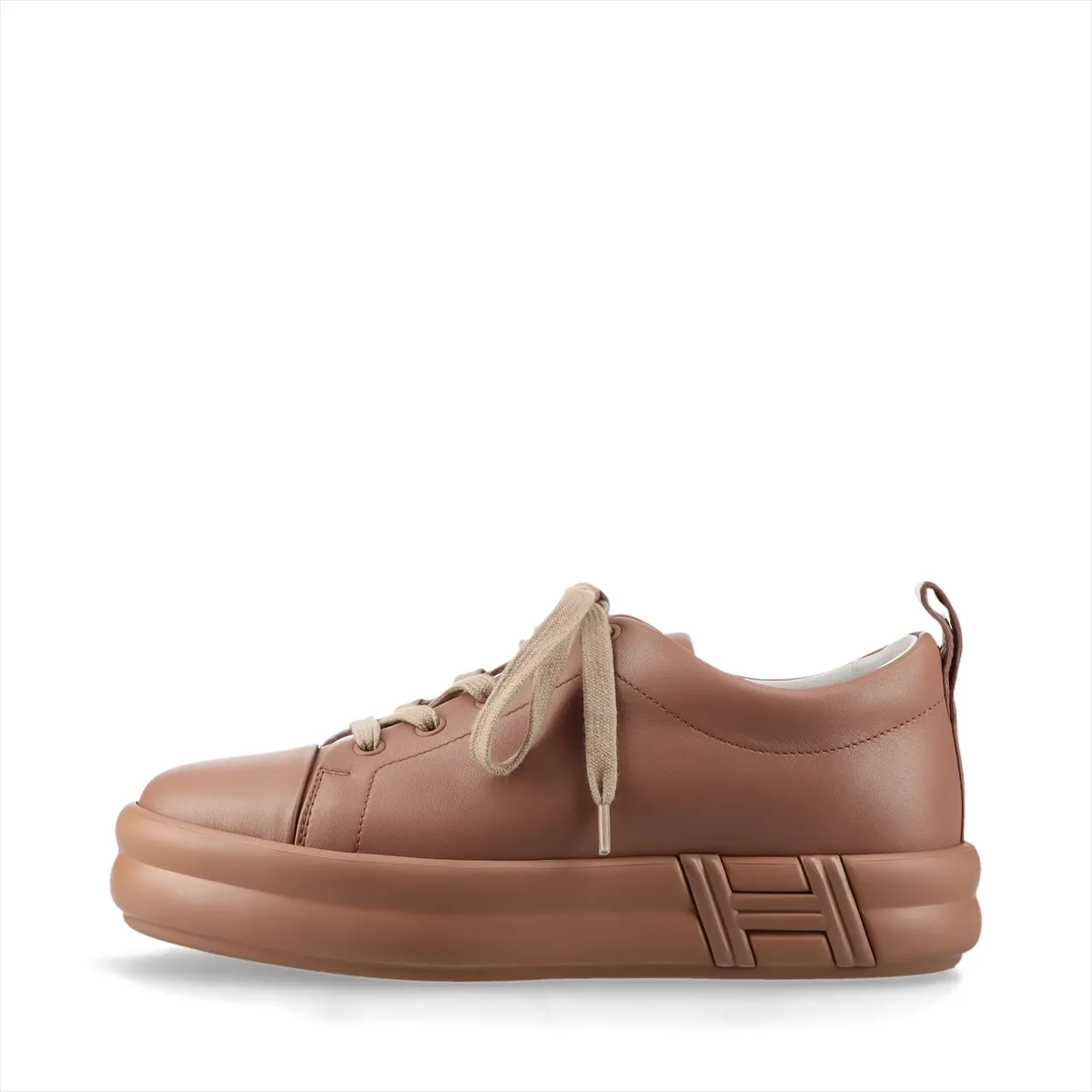 Low-top leather sneakers in a soft pink-brown tone with white soles.