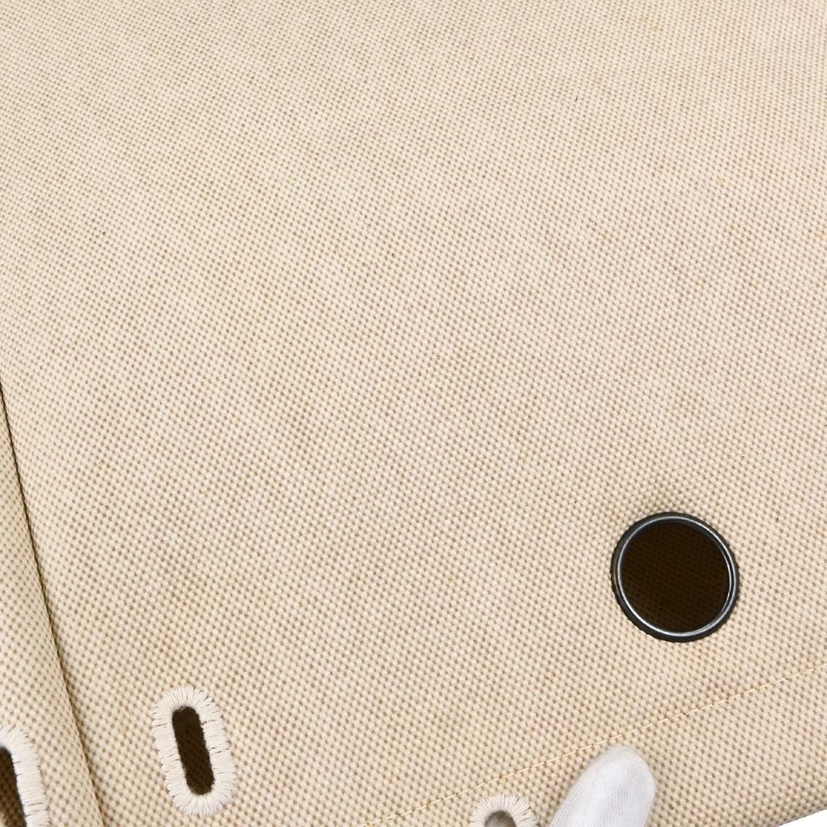 Canvas backpack with beige body, black leather trim and flap closure with straps.