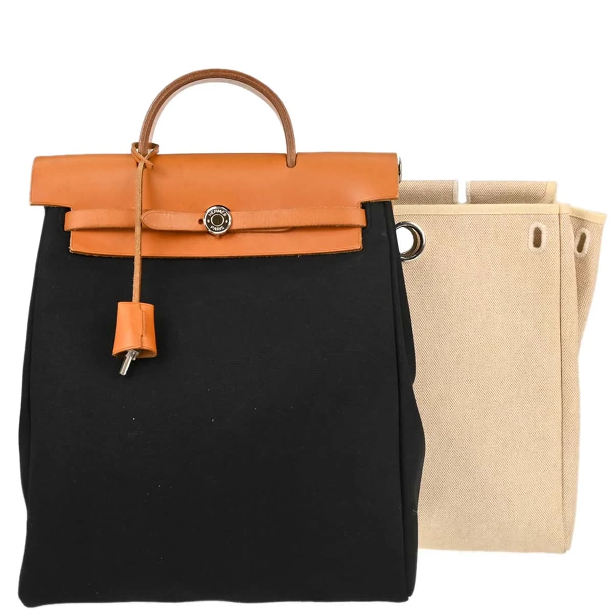 Canvas backpack with beige body, black leather trim and flap closure with straps.