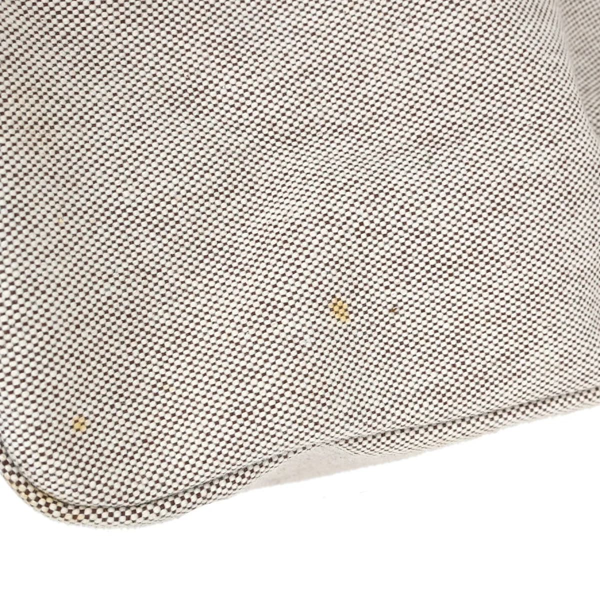 Trapeze-shaped canvas and leather bag with flap front, buckle closure and a long strap.