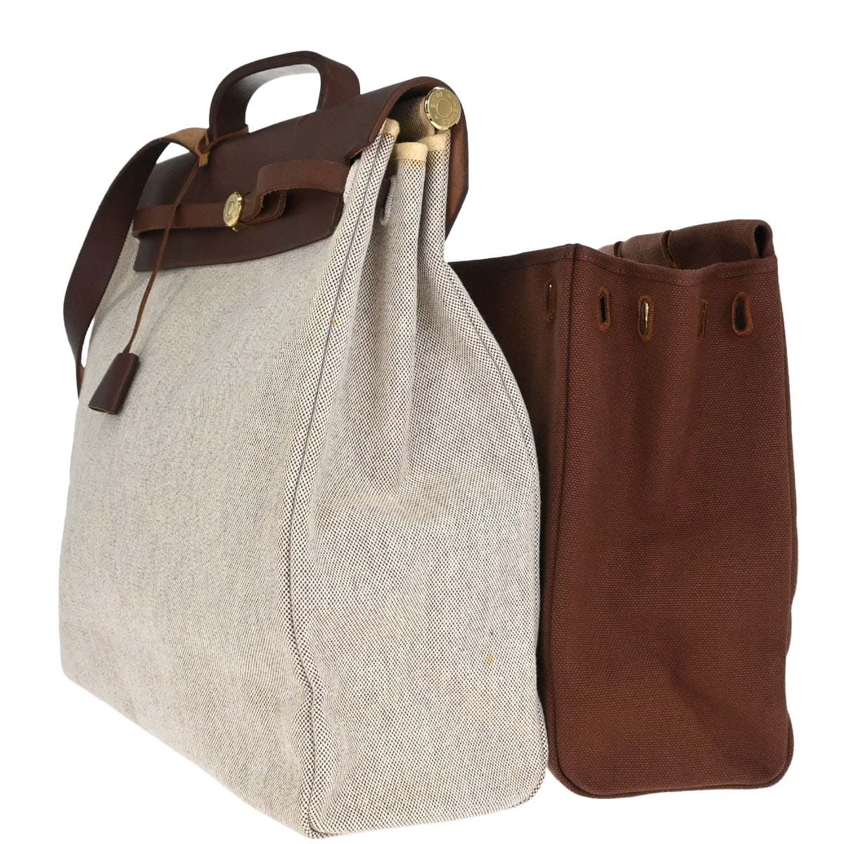 Trapeze-shaped canvas and leather bag with flap front, buckle closure and a long strap.