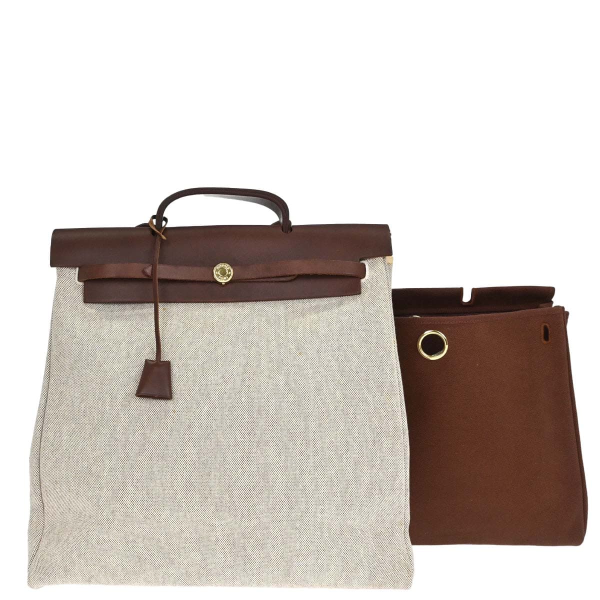 Trapeze-shaped canvas and leather bag with flap front, buckle closure and a long strap.