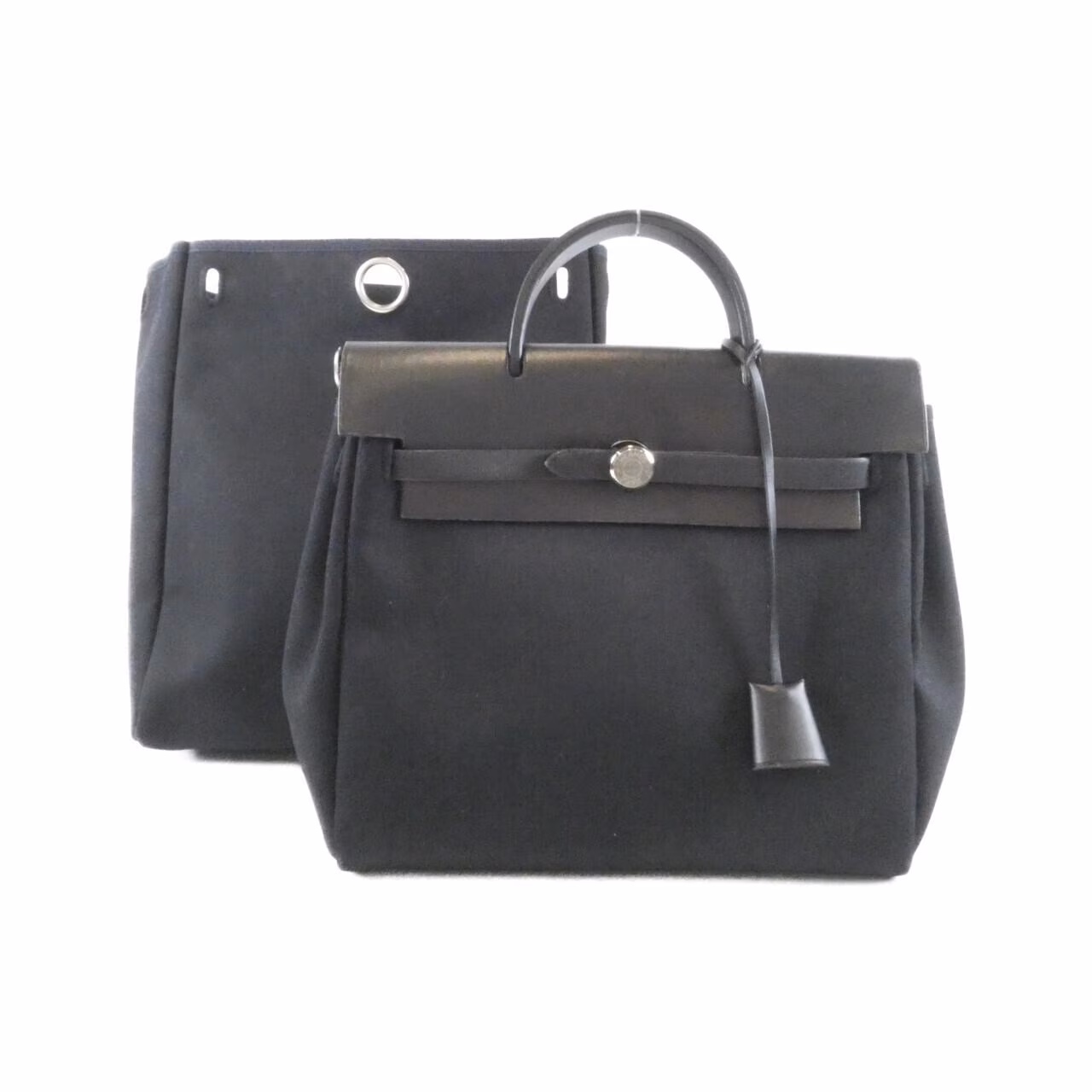 Canvas backpack with leather trim, flap closure and two shoulder straps.