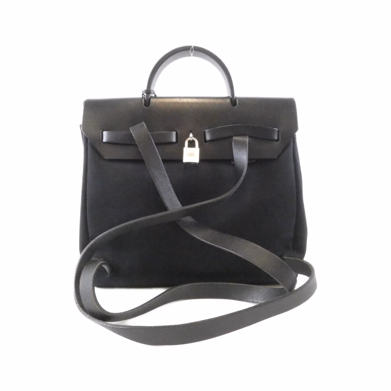 Canvas backpack with leather trim, flap closure and two shoulder straps.