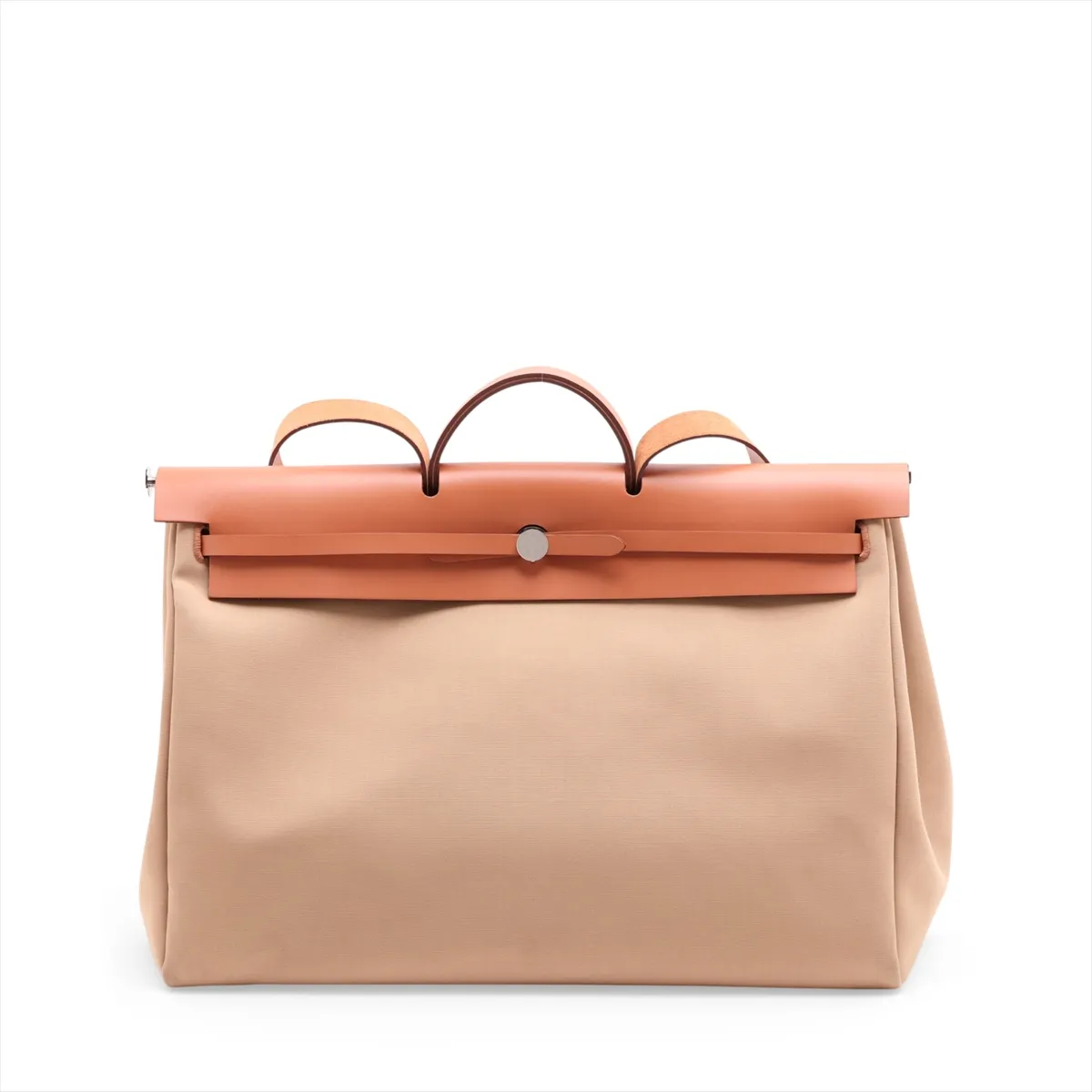 Beige canvas bag with tan leather flap and trim, front strap closure and a shoulder strap.