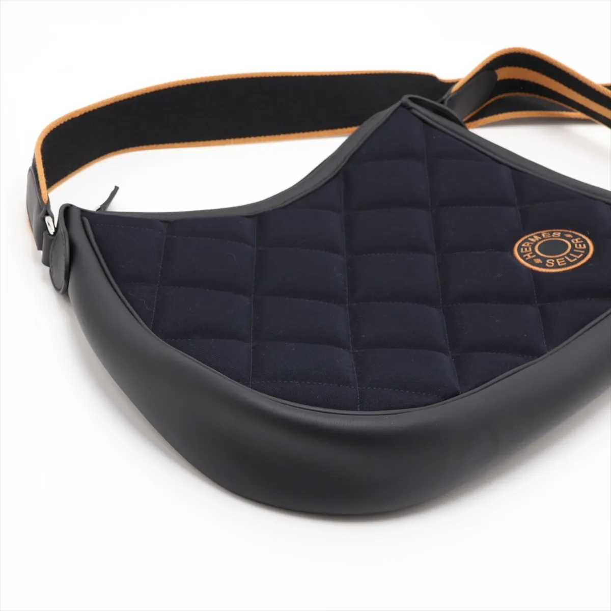 Navy canvas bag with black leather trim and silver-tone fittings.