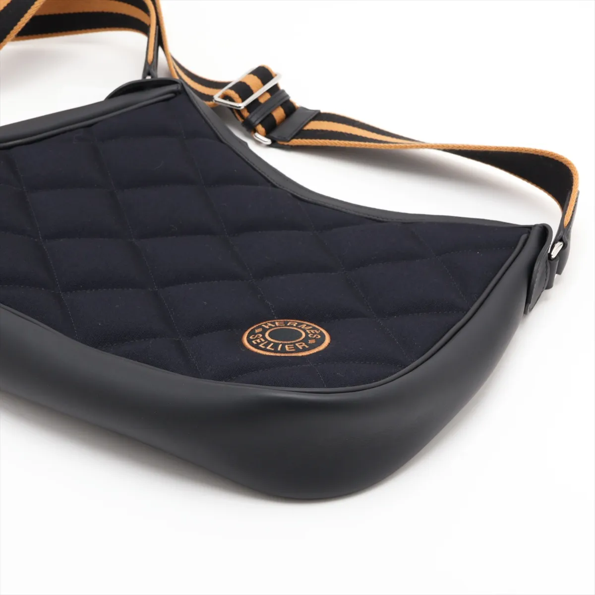 Navy canvas bag with black leather trim and silver-tone fittings.