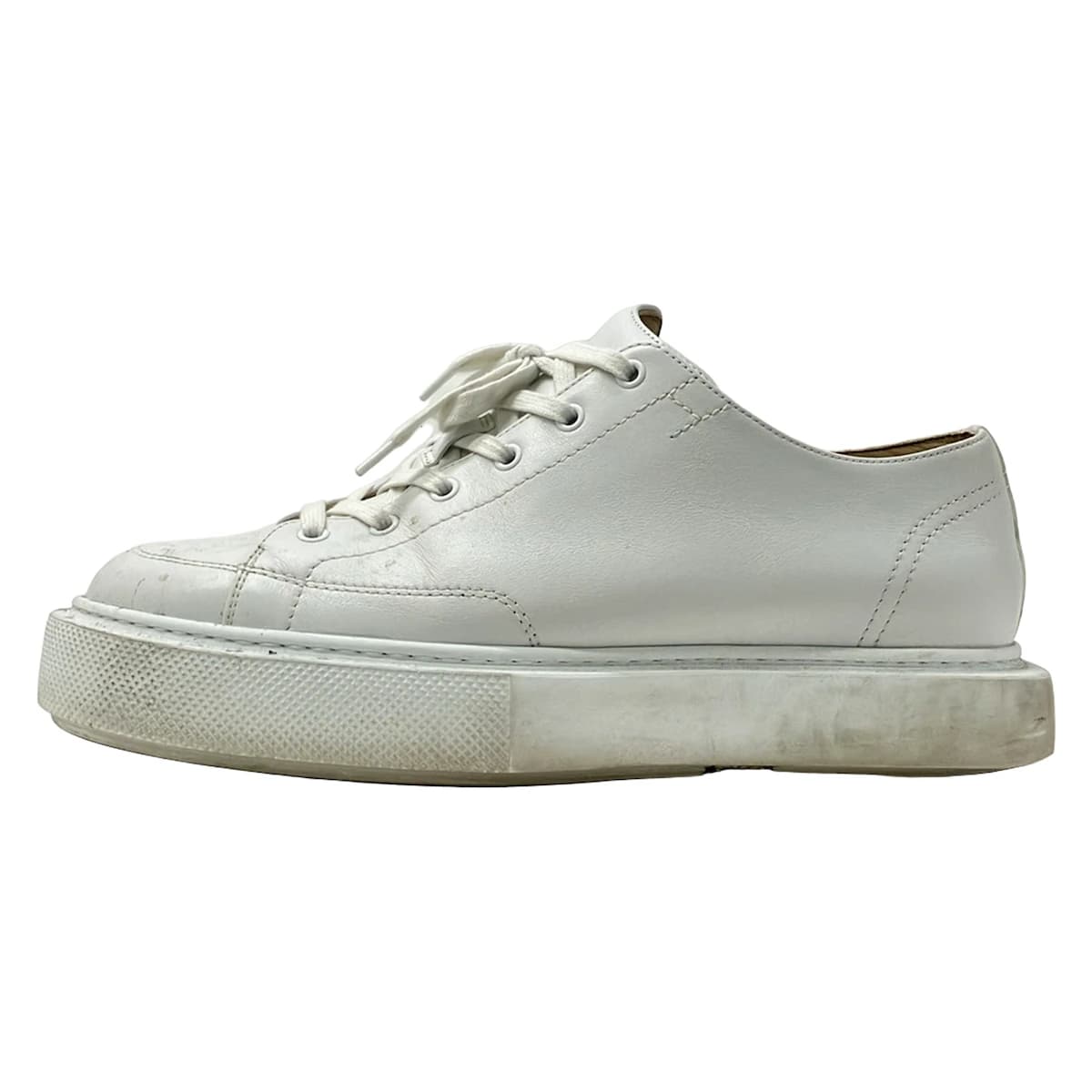 White leather low-top trainers photographed from the side.