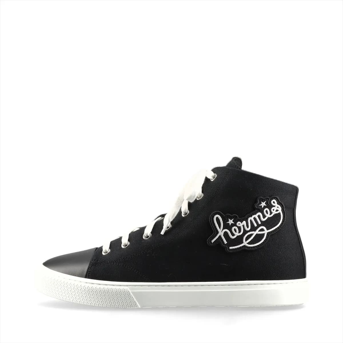 Black canvas and leather high-top sneaker with lace fastening and a white sole.