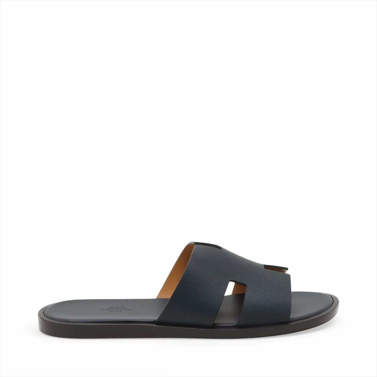 Pair of navy leather slide sandals with wide crossed straps, photographed on a plain background.