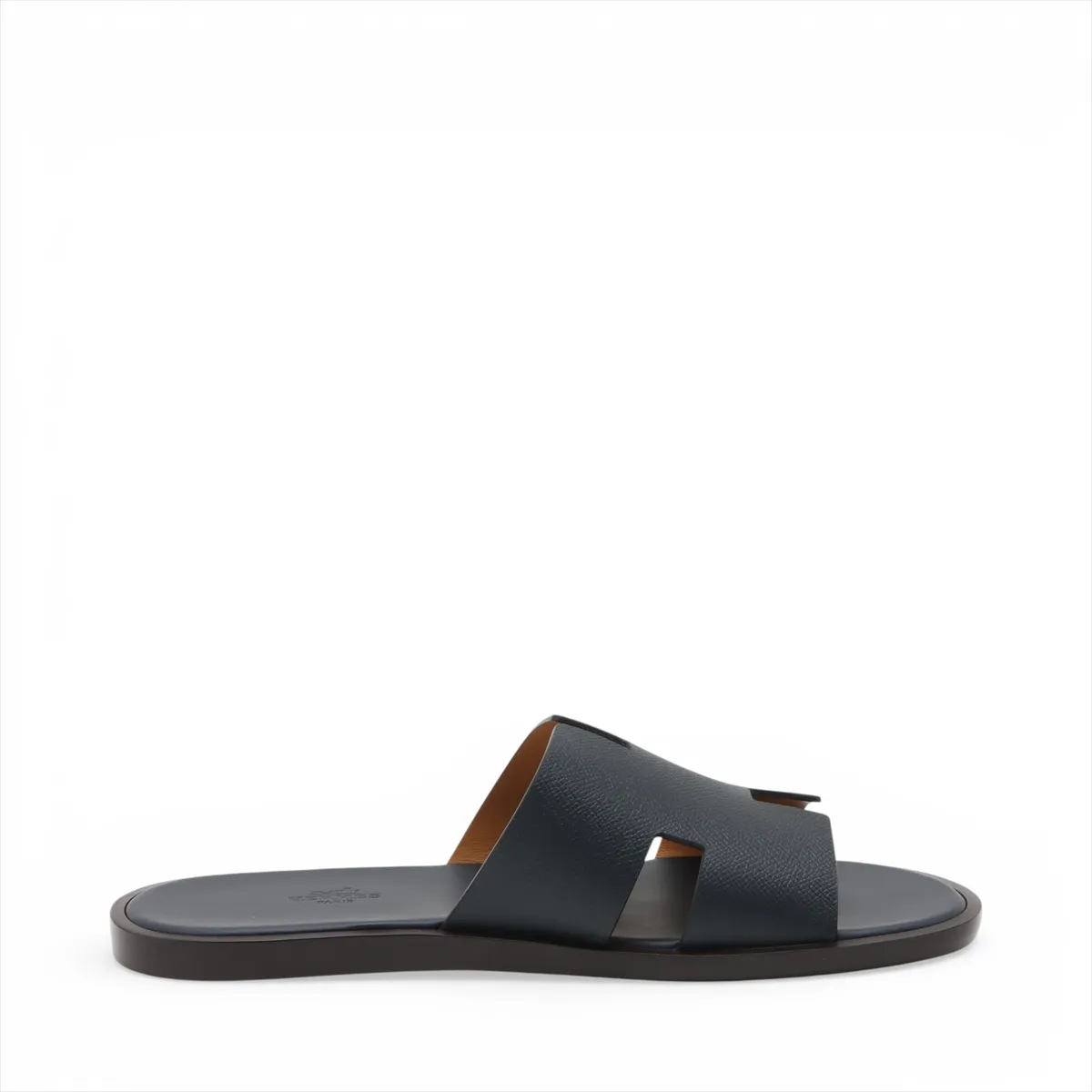 Pair of navy leather slide sandals with wide crossed straps, photographed on a plain background.