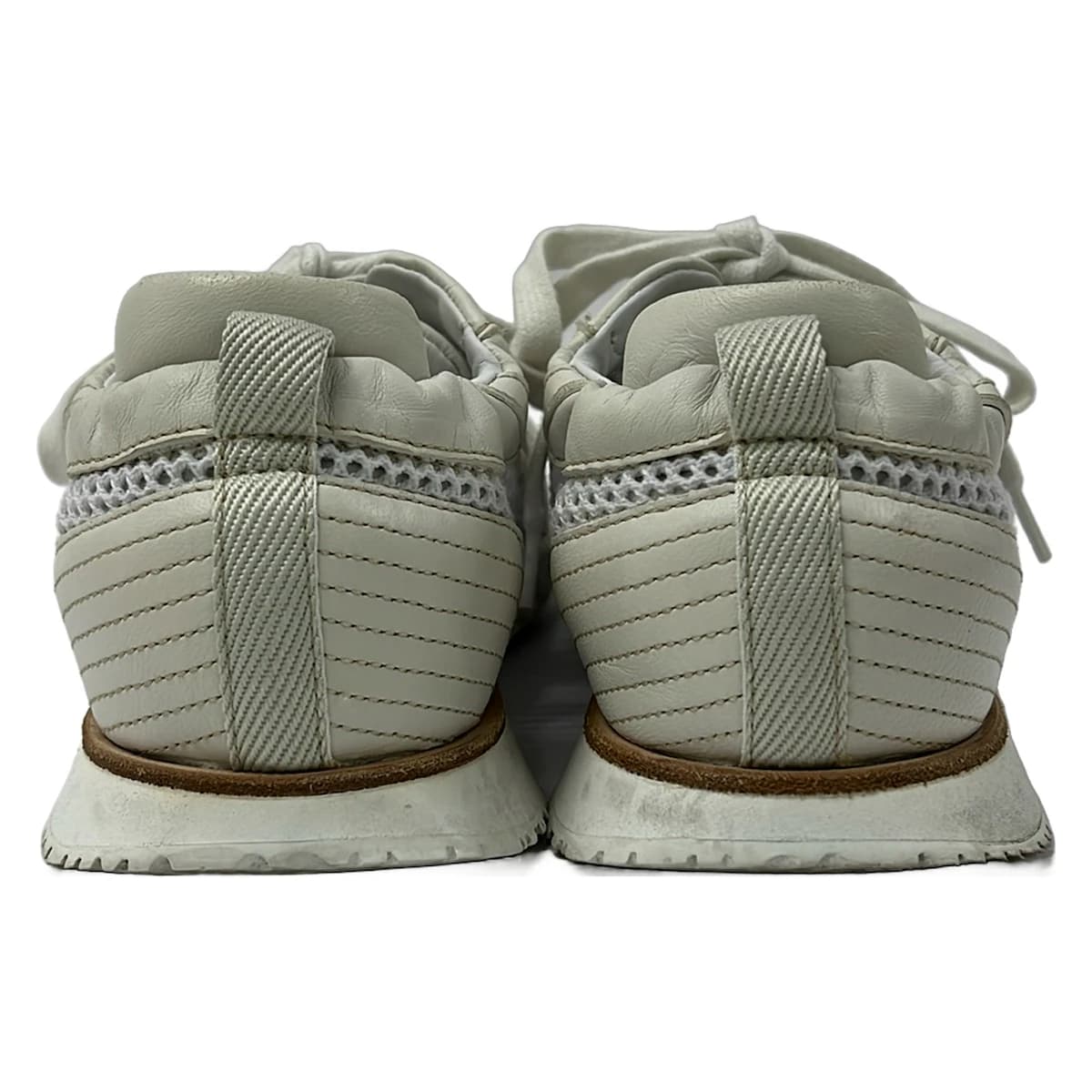 White mesh low-top shoe with leather panels, shown on a plain background.