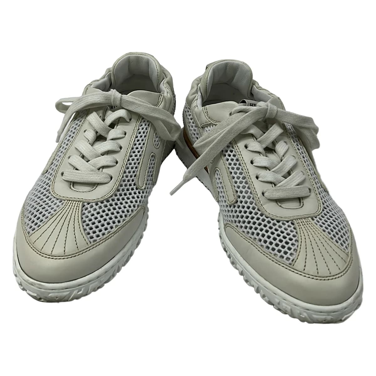White mesh low-top shoe with leather panels, shown on a plain background.