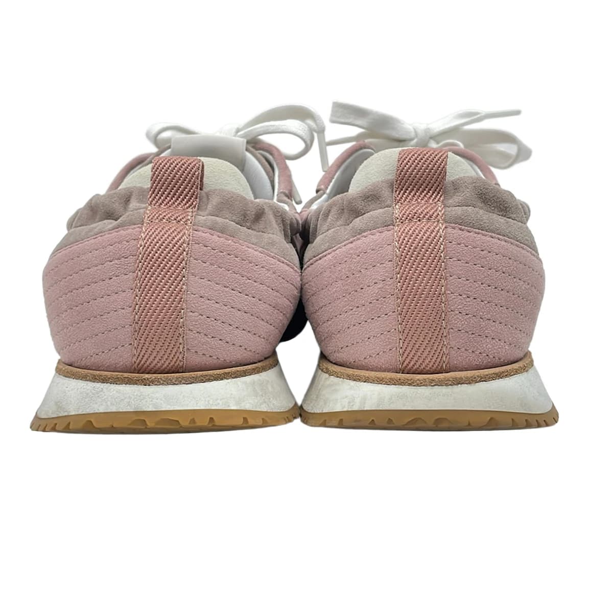 Pair of low-top lace-up shoes photographed side on against a plain background.