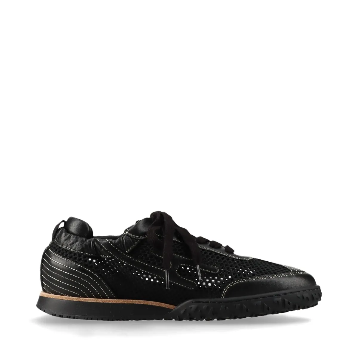 Black low-top sneakers with mesh panels and white soles.