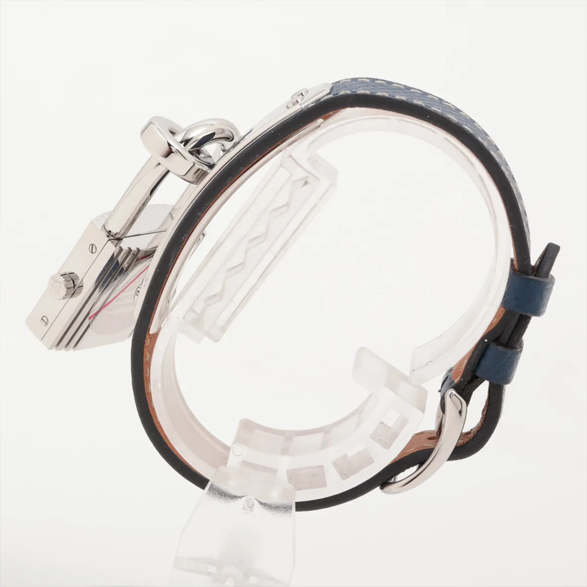Padlock-shaped steel watch with silver dial on a leather strap.