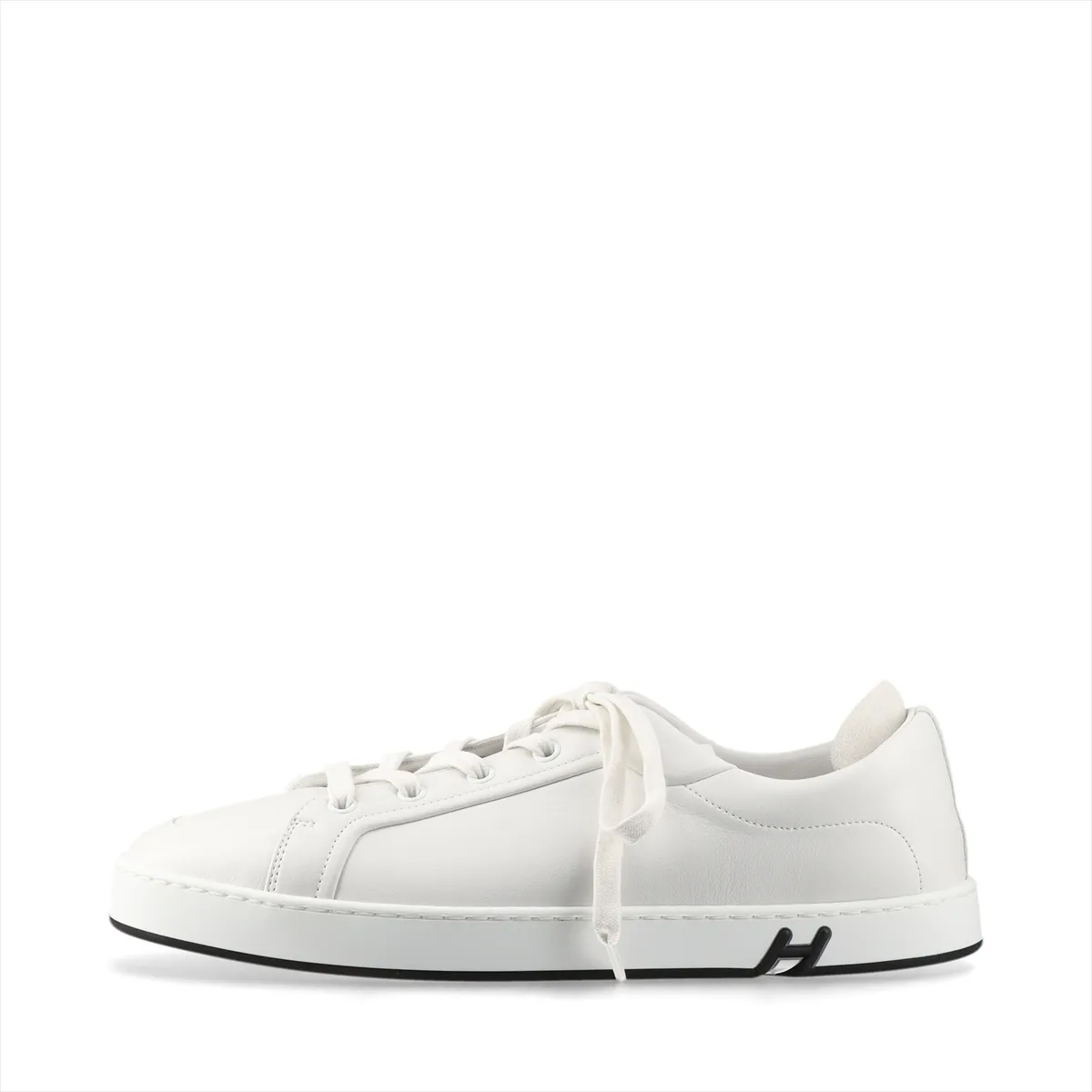White leather low-top sneakers with white laces and a white rubber sole.