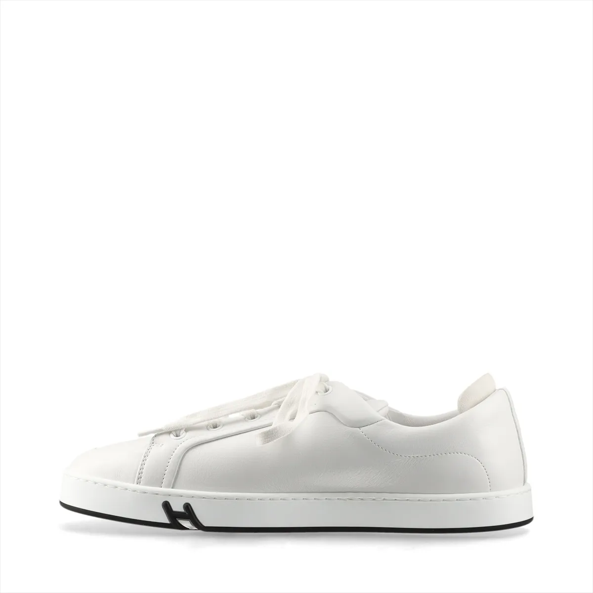 White leather low-top sneakers with white laces and a white rubber sole.