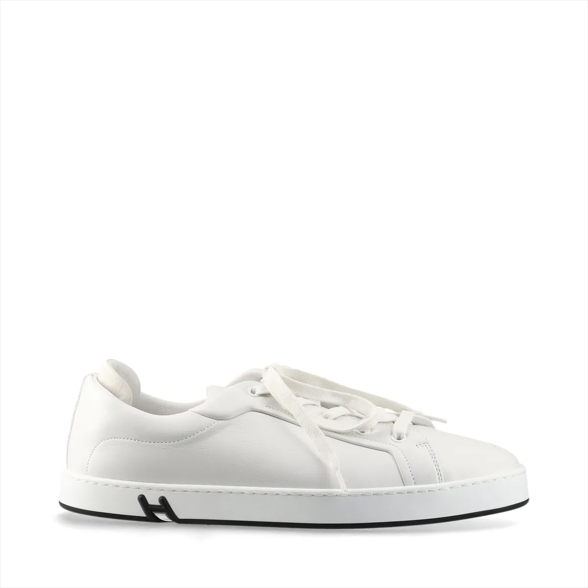 White leather low-top sneakers with white laces and a white rubber sole.