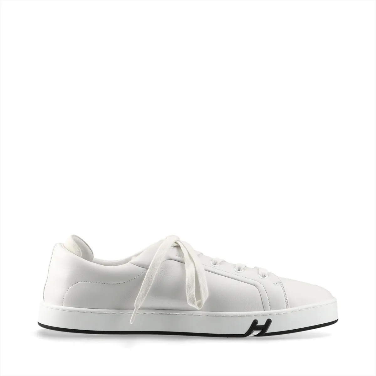 White leather low-top sneakers with white laces and a white rubber sole.