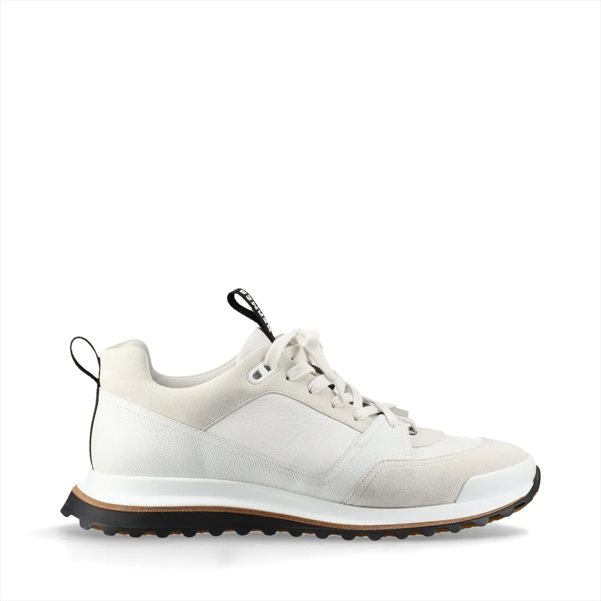 White low-top sneakers with mesh panels and black trim on a chunky white sole.