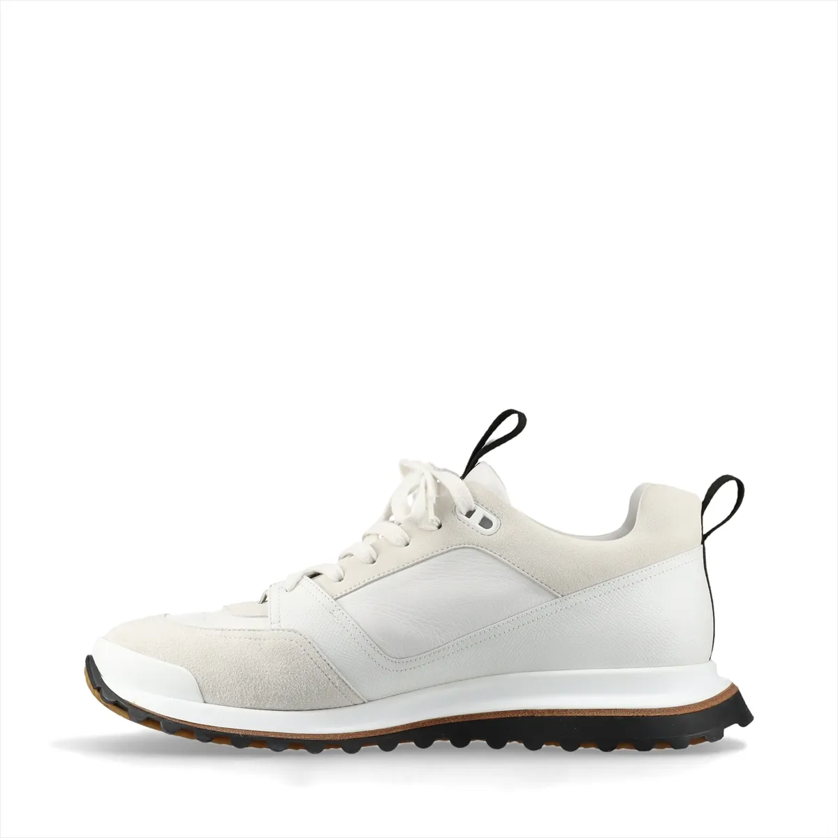 White low-top sneakers with mesh panels and black trim on a chunky white sole.