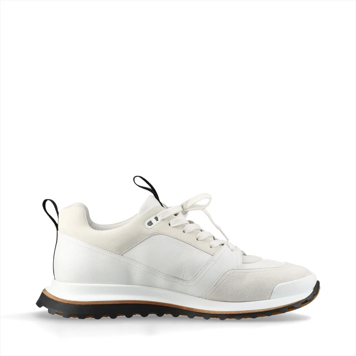 White low-top sneakers with mesh panels and black trim on a chunky white sole.
