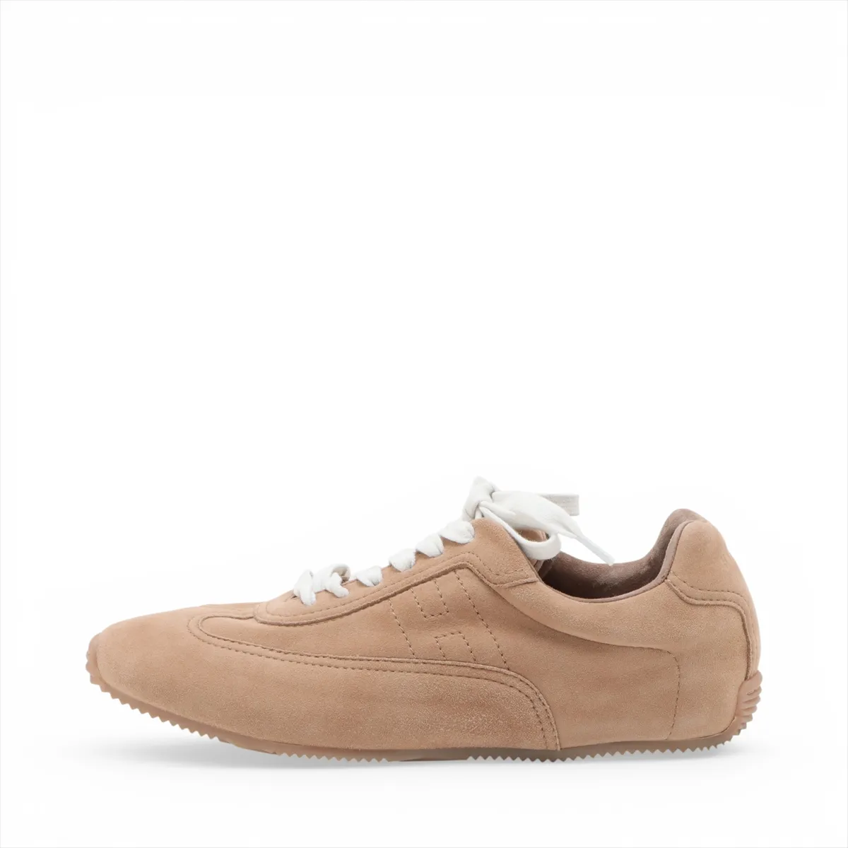 Beige suede low-top sneakers with white soles, side view.