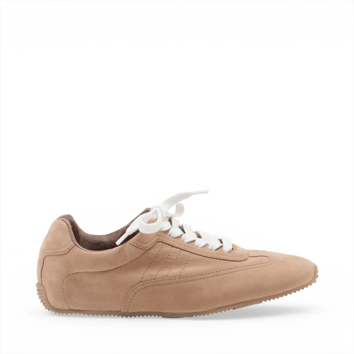 Beige suede low-top sneakers with white soles, side view.