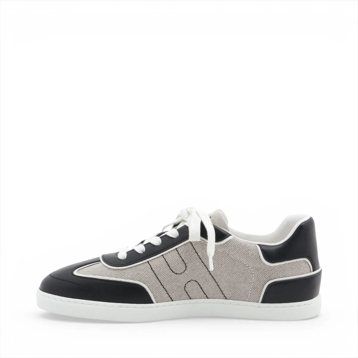 Black and grey low-top lace-up sneakers with white sole, photographed from the side.