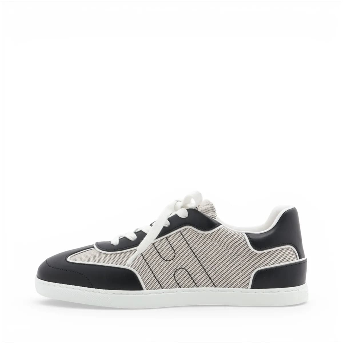 Black and grey low-top lace-up sneakers with white sole, photographed from the side.