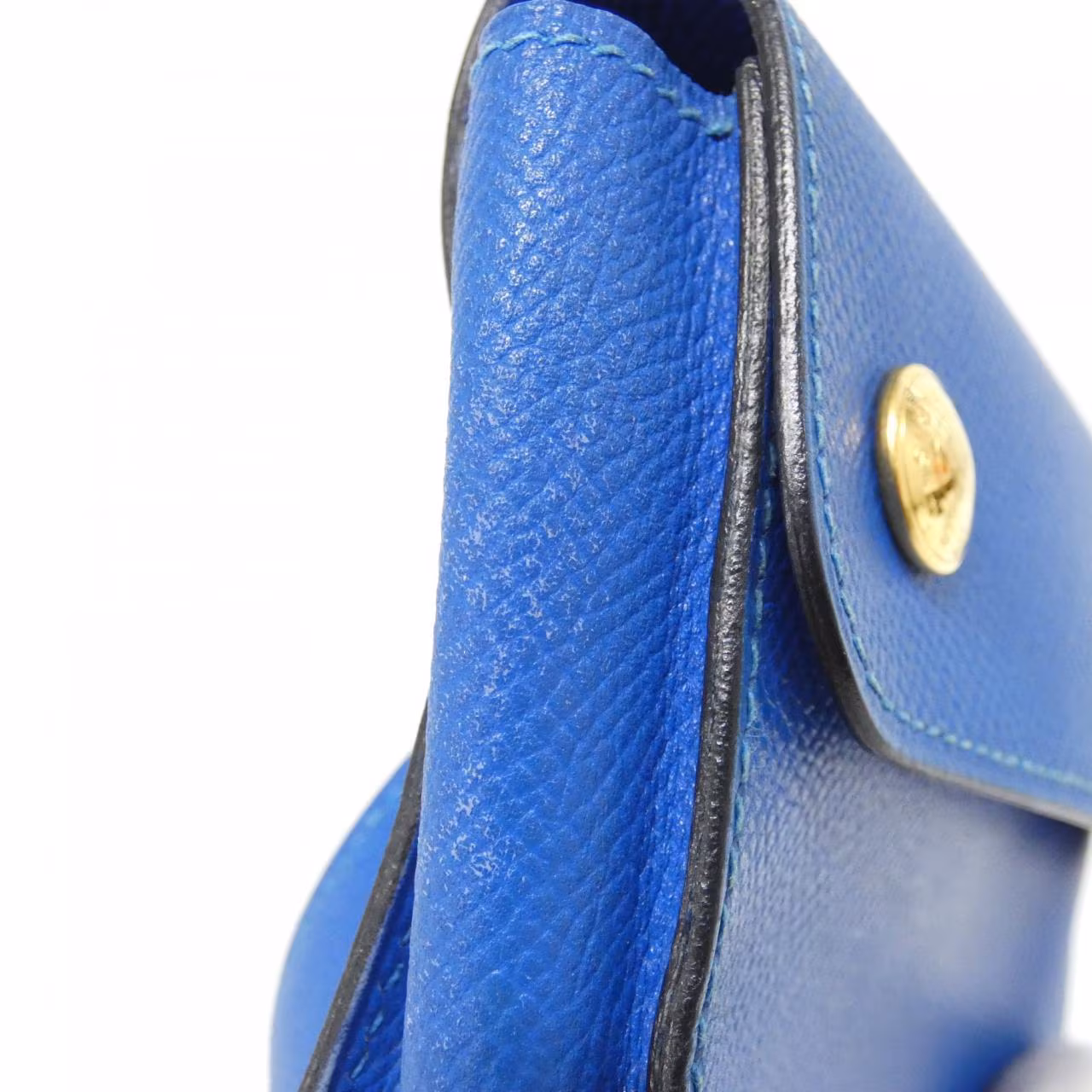 Small green belt bag with buckled strap.