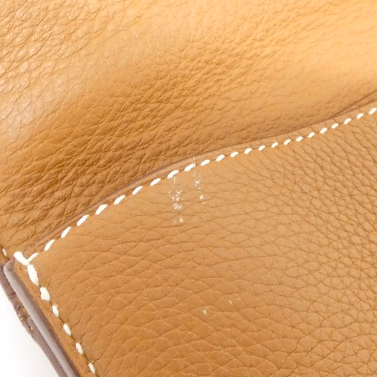 Structured rectangular leather briefcase with flap closure and top handle.