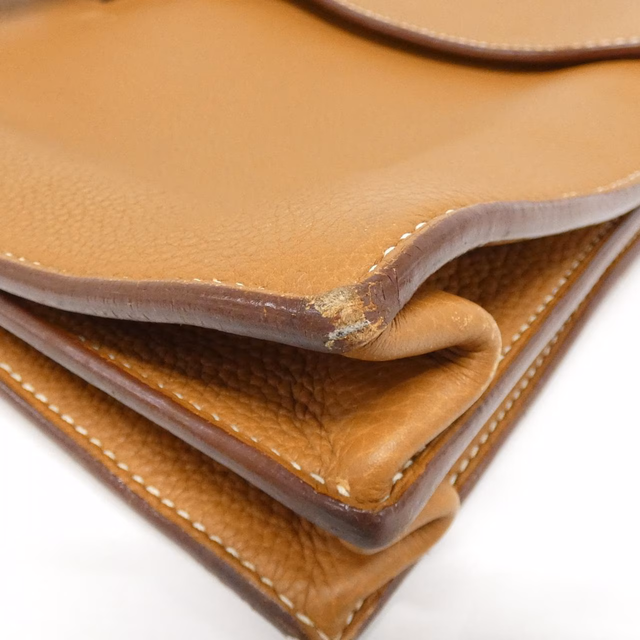 Structured rectangular leather briefcase with flap closure and top handle.