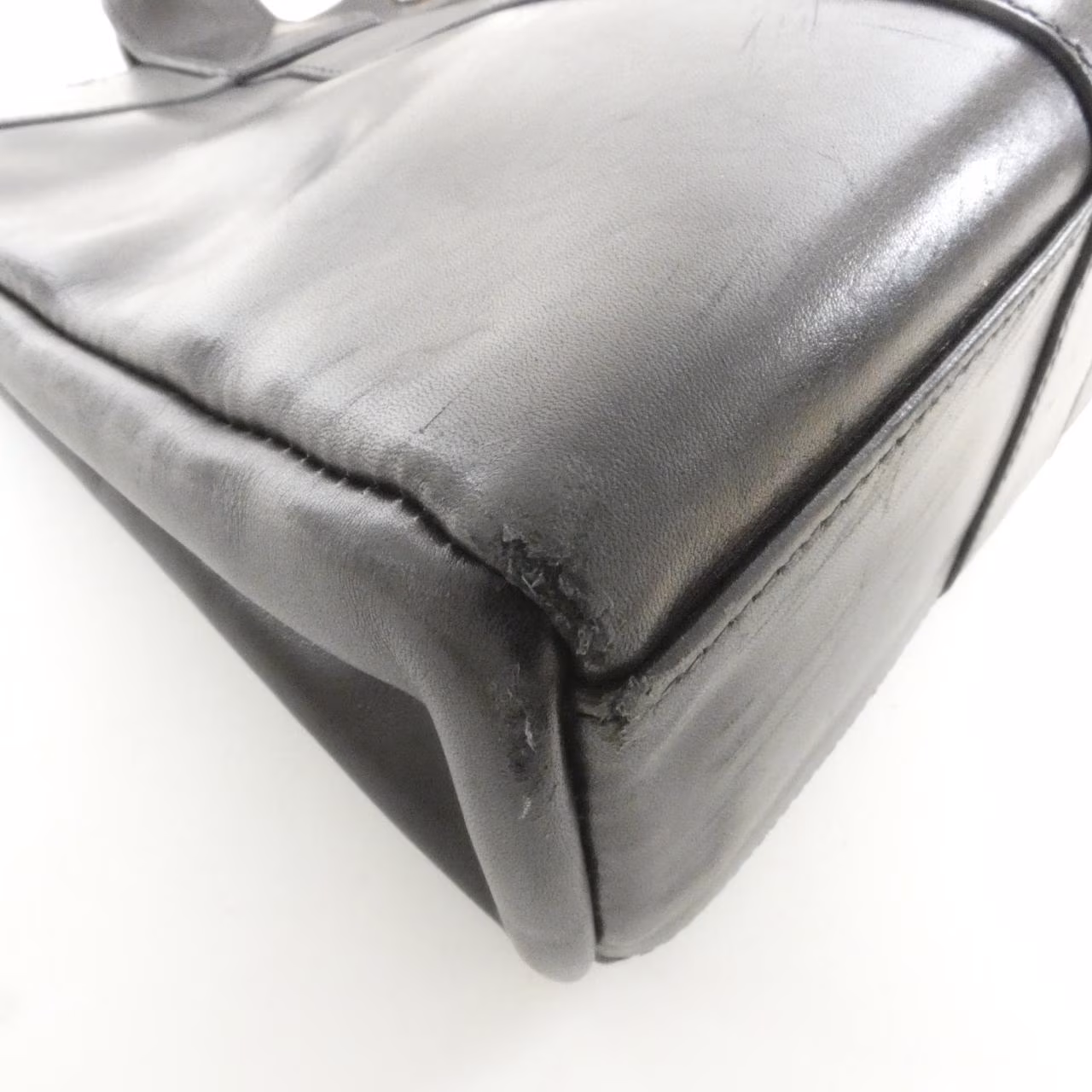 Canvas tote bag with leather-trimmed handles, shown upright.
