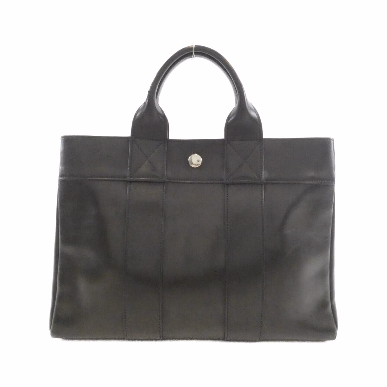 Canvas tote bag with leather-trimmed handles, shown upright.