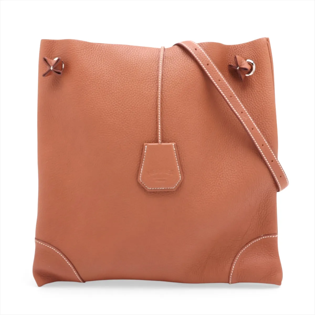 Tan leather shoulder bag with a flap front, canvas-lined body and silver hardware.