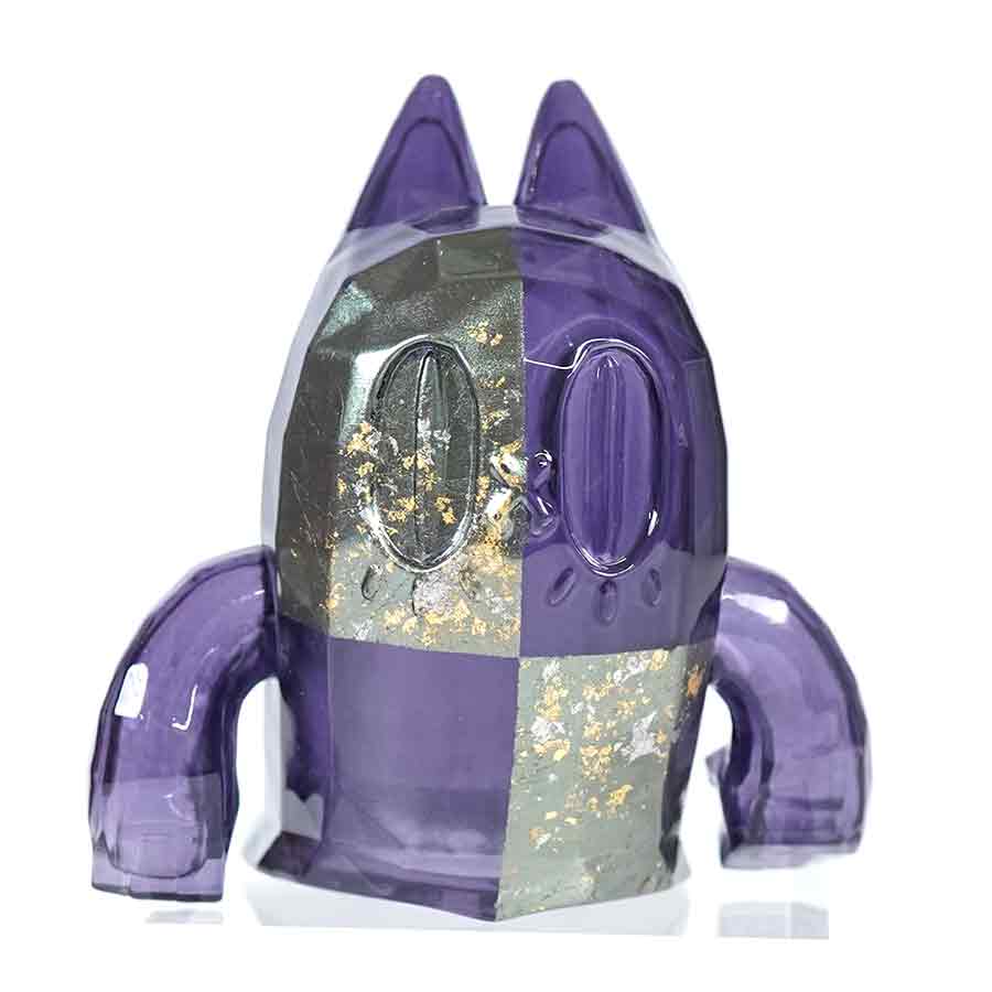 Small ghost-cat figure finished in purple checkerboard lacquer with metallic gold gradation.