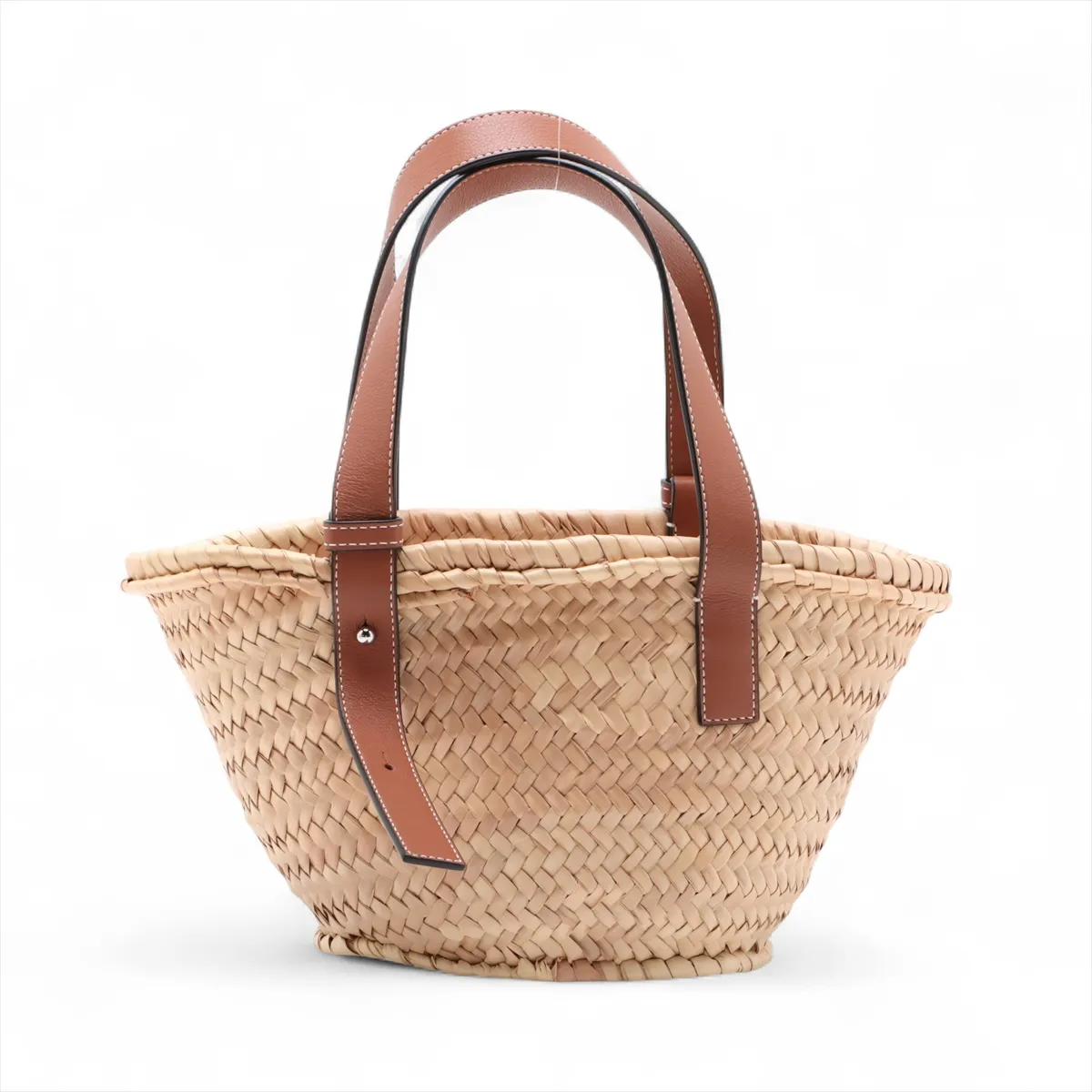 Woven natural straw basket bag with dark leather top trim and handles