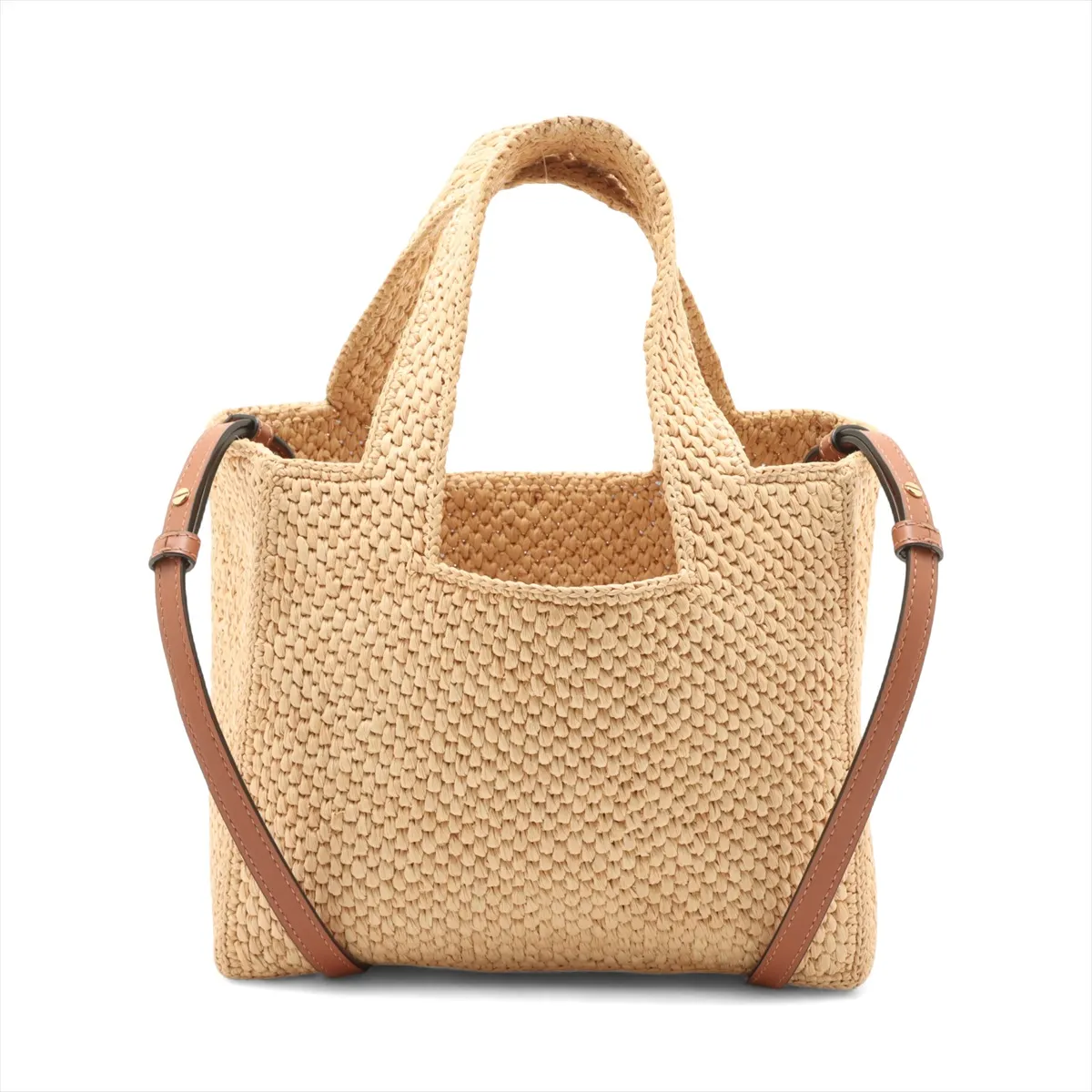 Beige woven raffia tote with leather handles and a lettered logo across the front