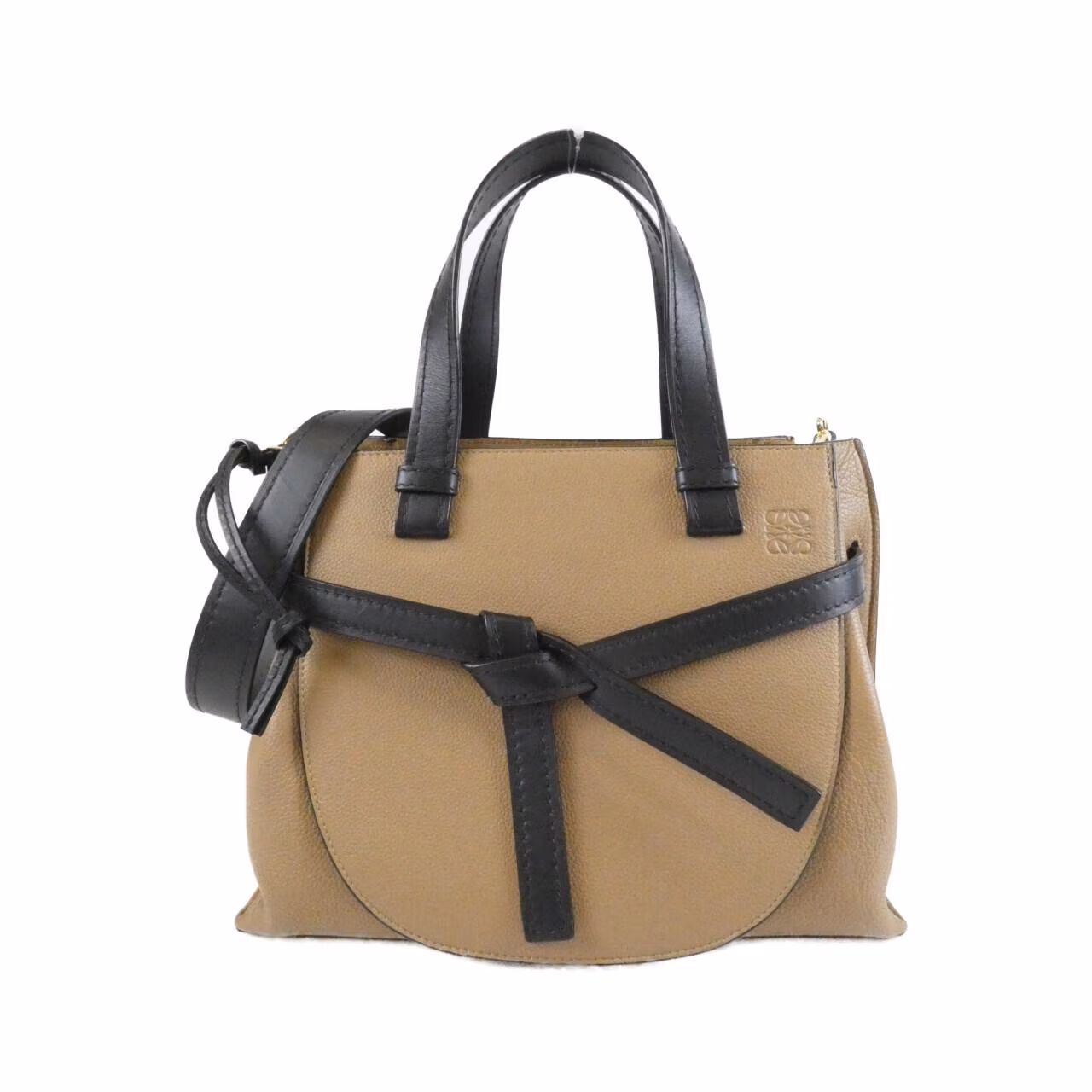 Small curved-flap bag with a top handle and knotted strap detail