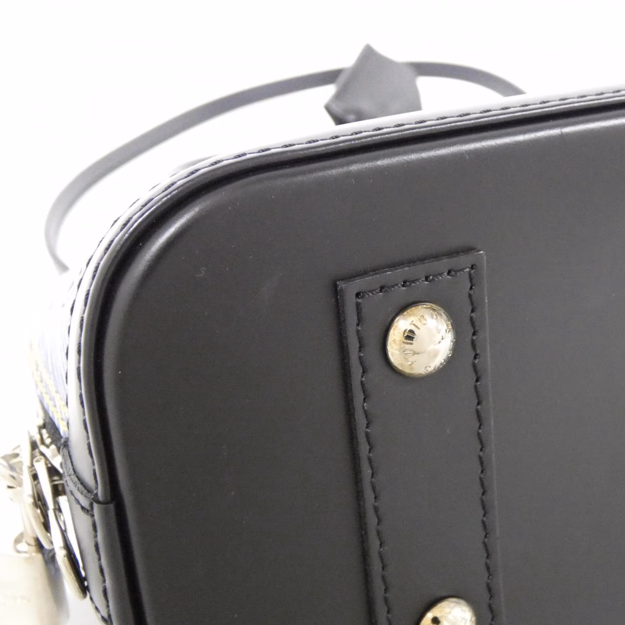 Small domed handbag with rounded top handles and a zip closure.