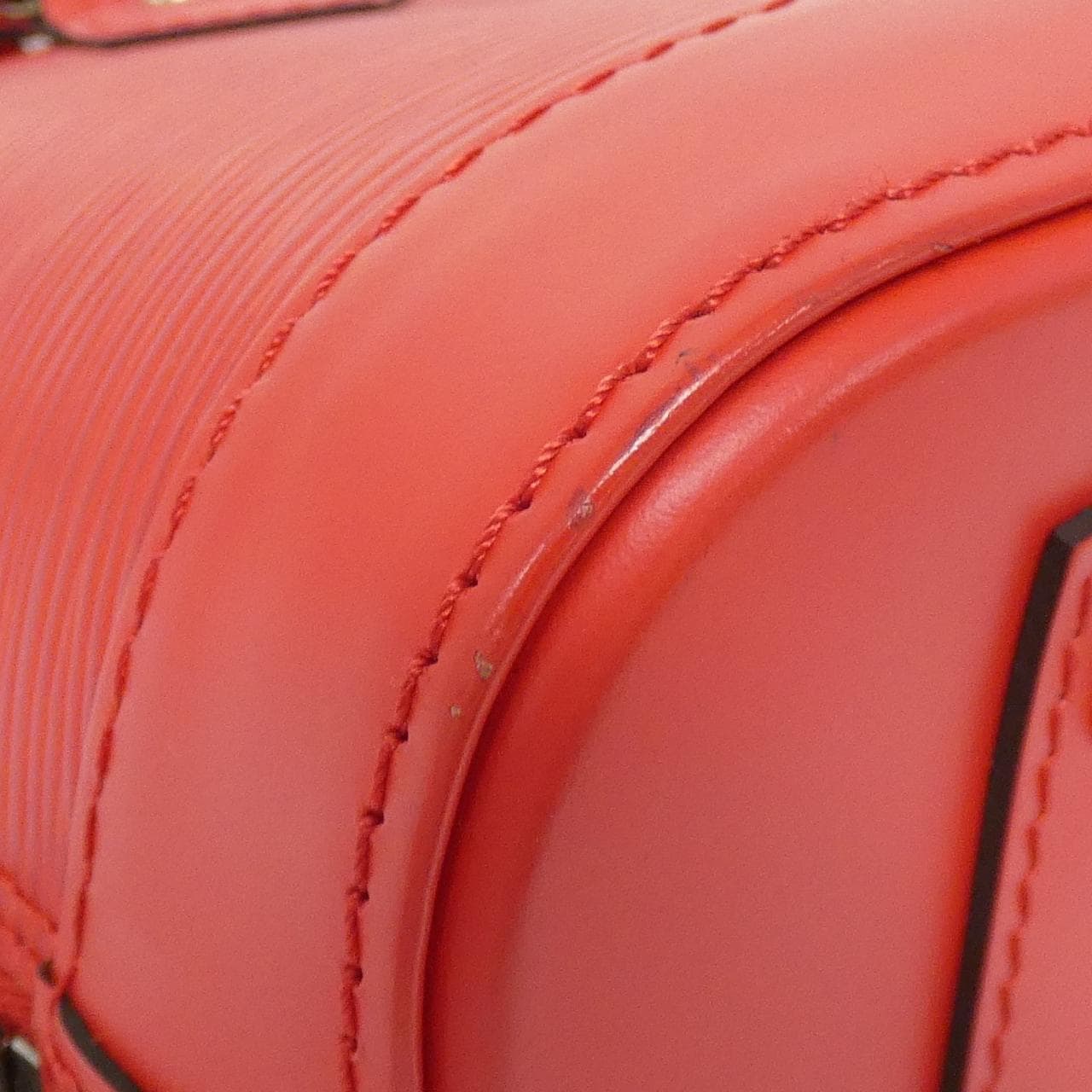 Small structured handbag in textured leather with twin top handles and a padlock detail.